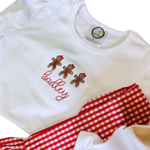 White shirt with gingerbread design and 'Hadley' text, paired with red and white gingham pants on a white background.
