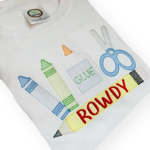 White shirt with colorful text and graphics including a pencil, crayons, glue, and scissors on a white background.