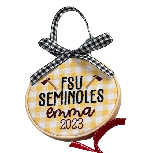 Decorative ornament with 'FSU Seminoles Emma 2023' text on a yellow checkered background.