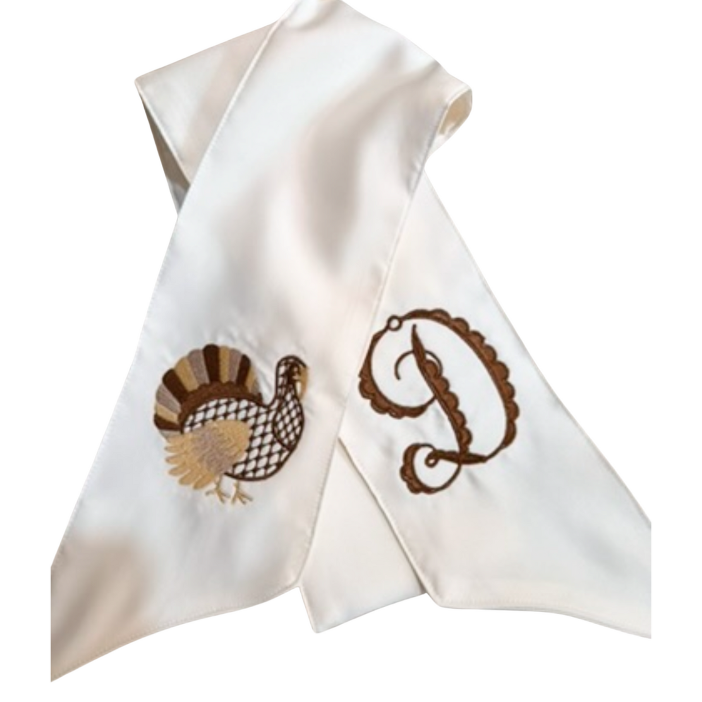 White napkin with embroidered turkey and letter 'P' design on a white background