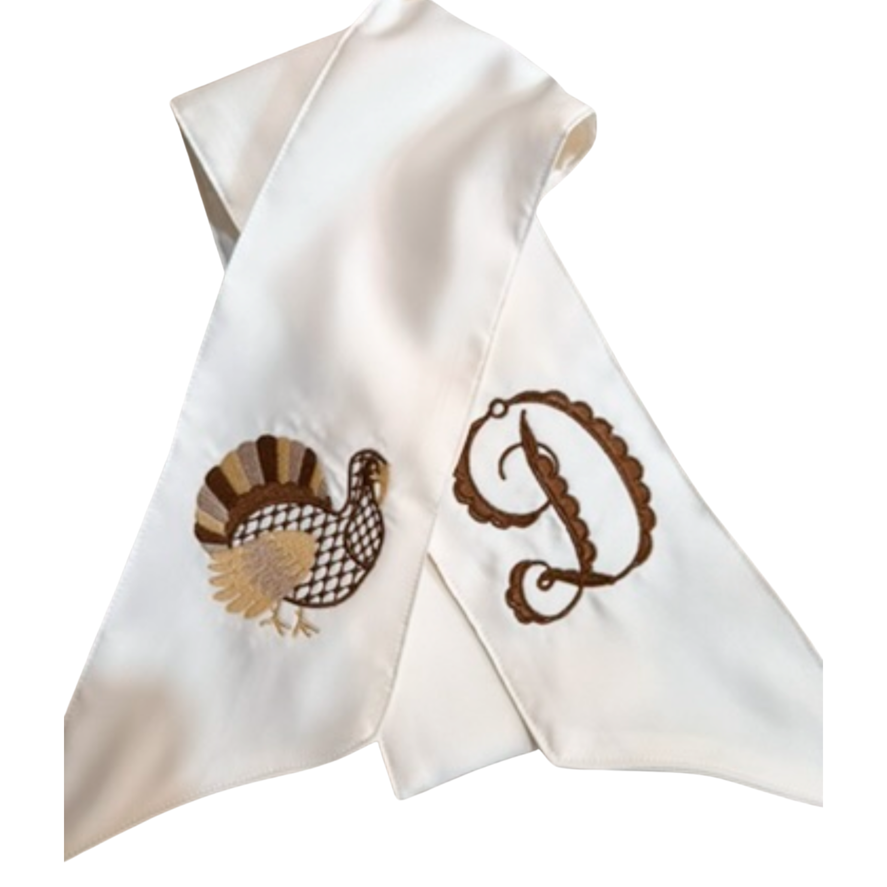 White napkin with embroidered turkey and letter 'P' design on a white background