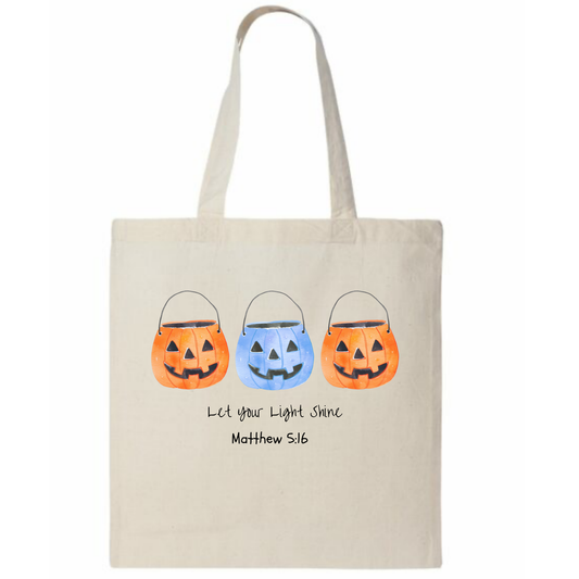 Tote bag with Halloween-themed design and text on a white background
