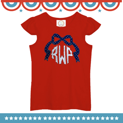 Red short sleeve shirt with USA Bow Frame Design featuring a blue polka dot bow and white monogram