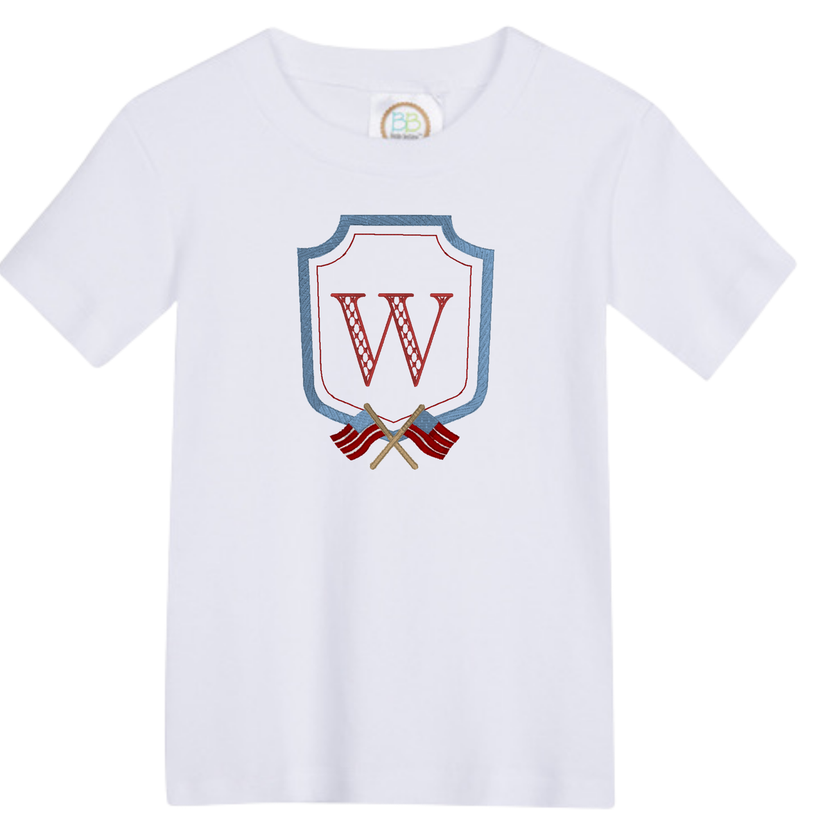 White t-shirt with a Flag Crest Design featuring a red letter W inside a blue shield with crossed flags
