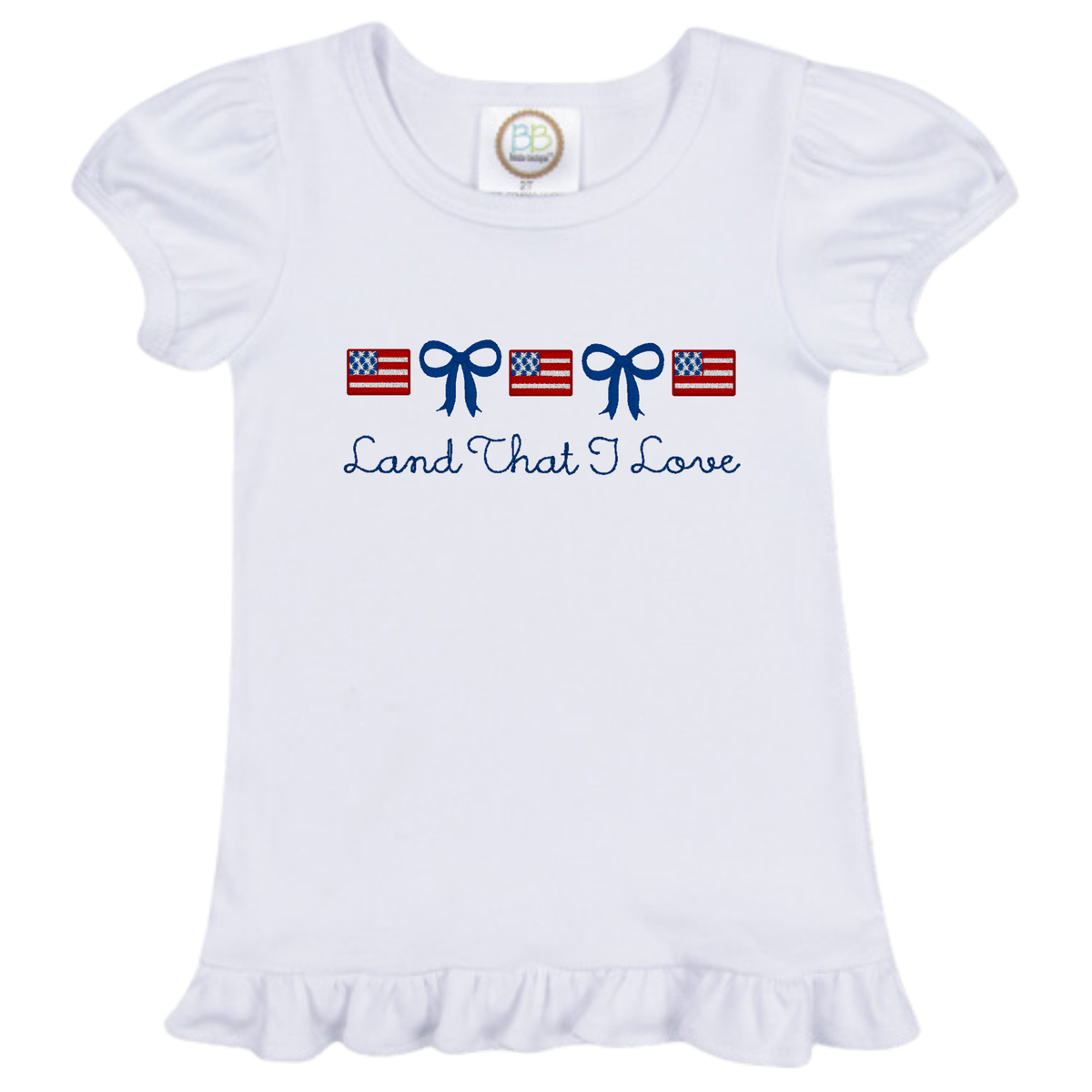 Little Lady Flag Design white ruffled t-shirt with American flag and blue bow graphics and Land That I Love text