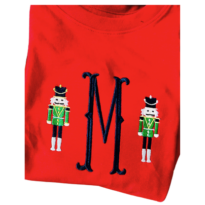 Red shirt with 'M' and nutcracker designs on a white background
