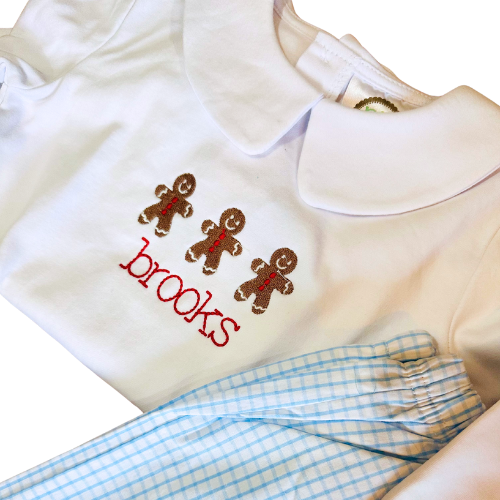 White shirt with embroidered gingerbread men and 'brooks' text, paired with blue checkered pants.